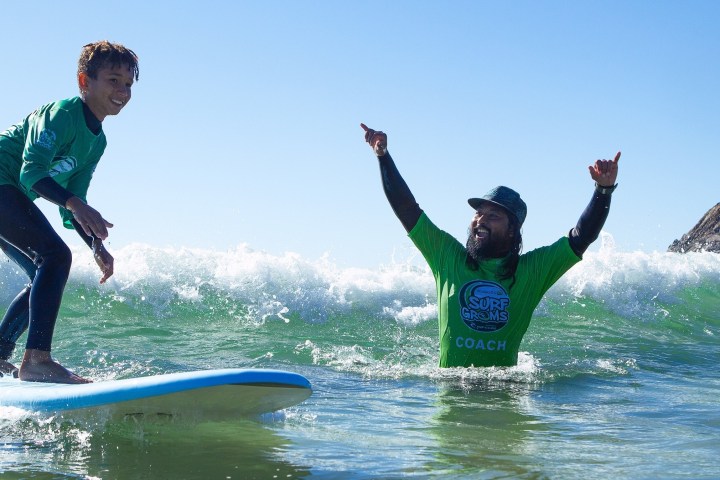 a man riding a wave on a surfboard in the water