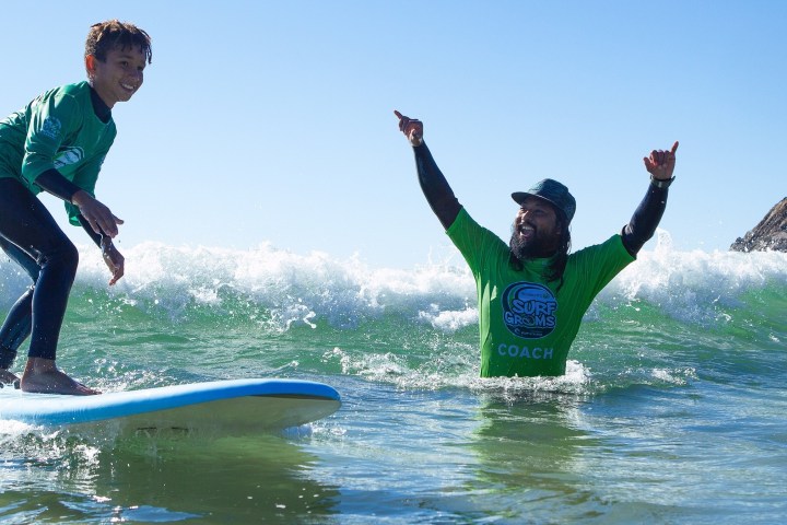a man riding a wave on a surfboard in the water