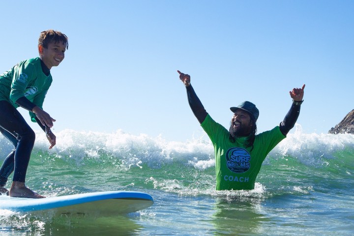 a man riding a wave on a surfboard in the water